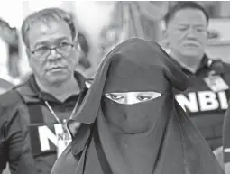  ??  ?? NAKED EYES — Karen Aizha Hamidon, the woman who was nabbed for allegedly recruiting Maute-ISIS fighters, appears at the Department of Justice (DOJ) in Manila for her preliminar­y trial on charges of rebellion yesterday. (Czar Dancel)