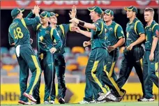  ??  ?? The Australian team celebrates after dismissing Sri Lanka's Lasith Malinga to give Australia victory in the first internatio­nal one-day cricket final at the Gabba in Brisbane, - AFP