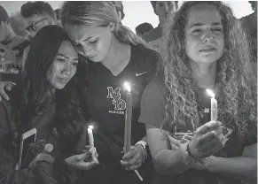  ?? USA TODAY NETWORK ?? From left, Sidney Ho, Jordan Strauss and Kendall Edgren attend a vigil Feb. 15 in Parkland, Fla.