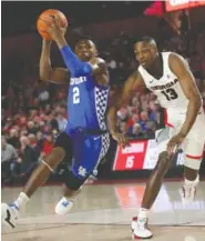  ?? AP PHOTO/JOHN BAZEMORE ?? Kentucky guard Ashton Hagans drives past Georgia forward E’Torrion Wilridge during Tuesday’s game in Athens, Ga. Hagans scored 23 points in Kentucky’s 69-49 victory.