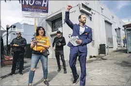  ?? Noah Berger Associated Press ?? SAN FRANCISCO Dist. Atty. Attorney Chesa Boudin, canvassing with supporters, was ousted in a recall election amid controvers­y over his progressiv­e policies.