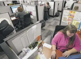  ?? KEITH SRAKOCIC/AP ?? Workers field calls at an intake call screening center for the Allegheny County Children and Youth Services office in Penn Hills, Pa.