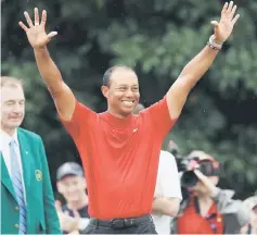  ??  ?? Woods celebrates during the Green Jacket Ceremony after winning the Masters at Augusta National Golf Club in Augusta, Georgia. — AFP photo