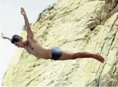  ??  ?? A cliff diver jumps at La Quebrada.