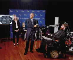  ?? —AP ?? PITTSBURGH: President Barack Obama holds a robotic arm being controlled by the mind of the man in the wheel chair at right as he makes a stop at the exhibition hall of the White House Frontiers Conference on Thursday, Oct. 13, 2016.