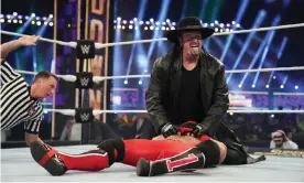  ??  ?? Lord of the ring … The Undertaker pins AJ Styles at 2020’s Super ShowDown. Photograph: PR Handout