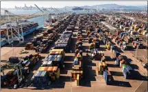  ?? NOAH BERGER / ASSOCIATED PRESS ?? Containers line a Port of Oakland shipping terminal on Wednesday in Oakland, Calif. Intense demand for products has led to a backlog of container ships outside the nation’s two largest ports along the Southern California coast.