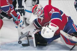  ?? THE CANADIAN PRESS ?? Habs goaltender Mike Condon reaches down to corral a bouncing puck during Sunday’s win over the Jets. With allstar Carey Price out with an injury, Condon turned in a solid effort between the pipes.