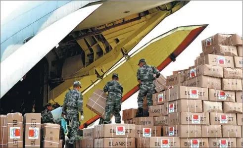  ?? ZHOU JIANHUA / FOR CHINA DAILY ?? Humanitari­an supplies are loaded onto a transport aircraft at an airport in Nanjing, Jiangsu province, before being transporte­d to Kathmandu, Nepal, after an earthquake in the country in 2015.