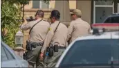  ?? Bobby Block/The Signal ?? Santa Clarita Valley Sheriff’s Station deputies enter a home on N. Weeping Willow Dr. in Valencia Monday after receiving reports of a man knocking on doors with an armed rifle in the area.