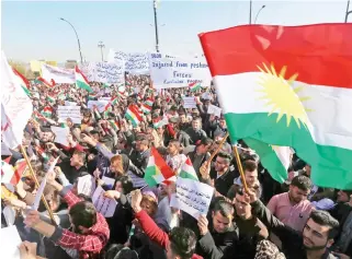  ??  ?? Iraqi Kurdish students of the Salahaddin University wave the Kurdish flag as they demonstrat­e in Irbil, the capital of autonomous Iraqi Kurdistan region, on Monday, against the Iraqi premier. (AFP)