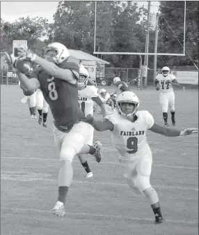  ?? Gary Comiskey/Special to Siloam Sunday ?? Colcord (Okla.) senior wide receiver Matthew Farris attempts to catch a pass during the first quarter of Thursday’s season-opening game against Fairland (Okla.). The Hornets defeated the Owls 27-0.