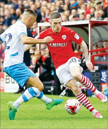  ??  ?? TAKE HIM ON: Barnsley’s Ryan Kent tries to outwit Sheffield Wednesday’s Jack Hunt