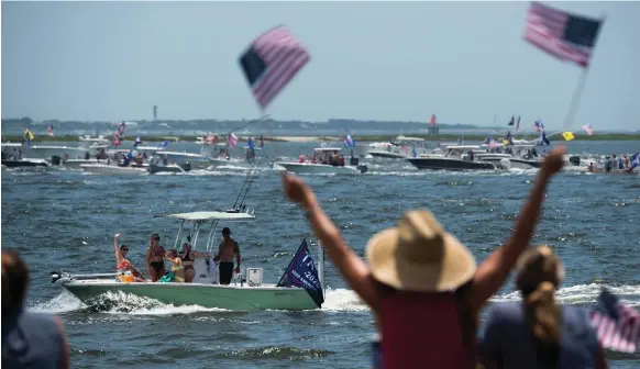  ?? Getty ?? Crowds gather at a harbour in Charleston, South Carolina, to watch a fleet of boats take part in a Make America Great Again parade on Sunday