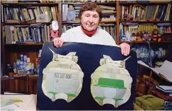  ??  ?? KOROLYOV, Russia: Galina Balashova, the artist who designed the first space habitation module for Soviet cosmonauts, shows drawings of her work in the city of Korolyov outside Moscow.