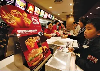  ??  ?? CUSTOMERS buy food at a McDonald’s restaurant in the southern city of Shenzhen January 29, 2010.