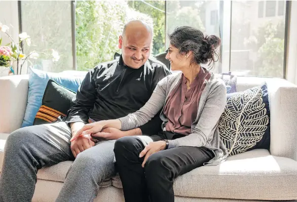  ?? NICK OTTO/THE WASHINGTON POST ?? Rahul Desikan, a researcher studying ALS at the University of California at San Francisco, and his wife, Maya Vijayaragh­avan, relax in their home.