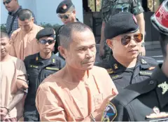  ?? APICHART JINAKUL ?? Three lese majeste suspects, from front to back, Pol Sgt Maj Prathin Chanket, Natthaphon Na Wanle and Jirawong Watthanath­ewasilp, arrive at court yesterday.