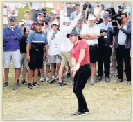  ??  ?? ALL EYES ON HIM McIlroy chipping on to the 13th green