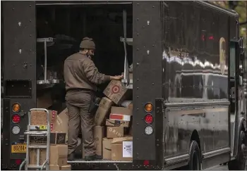  ?? VICTOR J. BLUE — BLOOMBERG ?? A United Parcel Service Inc. driver sorts boxes in New York on Oct. 13.