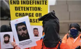  ?? Photograph: Thomas Krych/SOPA Images/REX/ Shuttersto­ck ?? A protester wearing a black hood holds a portrait of detainee Abu Zubaydah during a demonstrat­ion in London on Saturday.