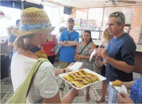  ?? PHOTOS BY LARRY OLMSTED ?? A guide from Miami Culinary Tours explains the signature pastry, guava pastelitos, at the Yisell Bakery.
