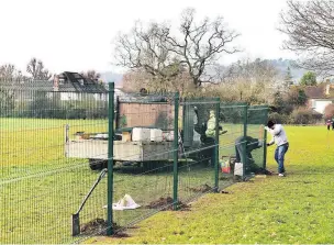  ??  ?? Work under way on the fence at Stoke Lodge playing fields