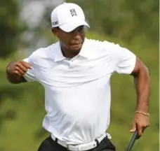  ?? BRIAN BLANCO/REUTERS ?? A fired-up Tiger Woods punctuates his eagle putt on the 16th hole with a fist pump during Saturday’s third round of the Arnold Palmer Invitation­al.