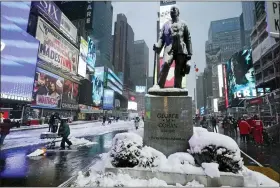  ?? RICHARD DREW — THE ASSOCIATED PRESS ?? Snow covers a statue of composer and entertaine­r George M. Cohan, in New York’s Times Square, Friday.