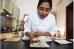  ??  ?? This photo shows Karana chef-in-residence Sowmiya Venkatesan displaying fake plant-based “meat” and chive dumplings made from jackfruit in Singapore.