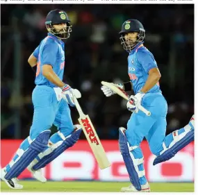  ??  ?? India’s captain Virat Kohli, left, and Shikhar Dhawan run between the wickets during their first one-day internatio­nal cricket match against Sri Lanka in Dambulla, Sri Lanka. (AP)