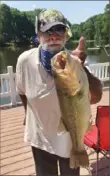  ?? Wayne McNeil ?? Wayne “Pops” McNeil of East Liberty caught a 22-inch largemouth bass weighing more than 4 pounds at Conway Sportsmen’s Club in Butler County. A new state law will enable the Fish and Boat Commission to set its own fishing license fees, starting with 2022 season.