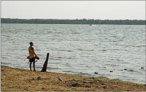  ?? ?? A lifeguard looks out over Oneida Lake at Verona Beach State Park.