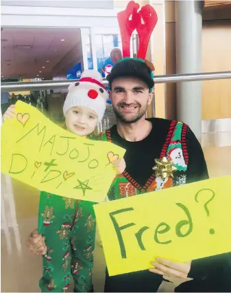  ??  ?? Adam Dewolfe and his daughter Lou dress up to greet family from Montreal at Victoria airport on Friday.