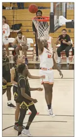  ?? Shelly Thorene
/ Union Democrat ?? Columbia College Claim Jumper Noel Alexander (25, above) jumps for the basket
during Wednesday’s game against the Chabot College Gladiators at the Oak Pavilion. Head Coach Rob Hoyt (right) talks to
the players during a time-out.