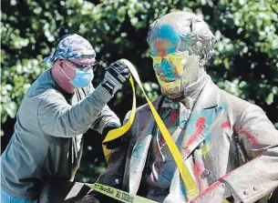  ?? STEVE HELBER THE ASSOCIATED PRESS ?? Confederat­e Naval officer Matthew Fontaine Maury’s statue is the second removed in Richmond.