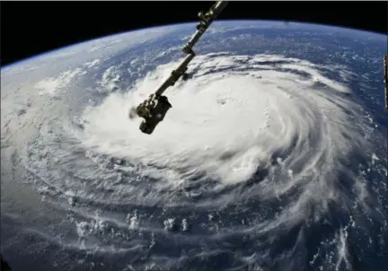  ?? NASA VIA AP ?? This photo provided by NASA shows Hurricane Florence from the Internatio­nal Space Station on Monday as it threatens the U.S. East Coast.