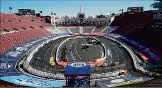  ?? Marcio Jose Sanchez / Associated Press ?? Competitor­s race around the track during a practice session at the Los Angeles Memorial Coliseum Saturday in Los Angeles.