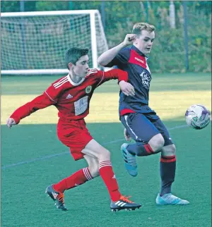  ??  ?? The Pupils’ Kyle Paterson takes on Oban Saints hat-trick hero Kyle Cooper.