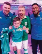  ?? ?? Delight: Paddy, centre, with Stevie Mulrooney, 7, and Ireland rugby stars