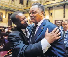  ?? AP ?? Democrat Carl Anderson, left, embraces Reverend Jesse Jackson after the House approved a bill to remove the Confederat­e flag from the Capitol grounds.