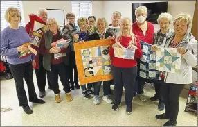  ?? Submitted photo ?? Attendees of the very first Silver Needles Quilt Retreat, held Feb. 23-25, show off their masterpiec­es during the retreat.