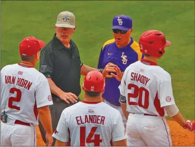  ?? Associated Press ?? Salty words: LSU coach Paul Mainieri, upper right, is separated from Arkansas coach Dave Van Horn (2) by an umpire as they discuss a collision at second base during the fourth inning of the Southeaste­rn Conference NCAA college baseball tournament,...