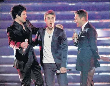  ?? Kevin Winter Getty Images ?? ADAM LAMBERT, left, is runner-up to Kris Allen on “American Idol” in 2009, and host Ryan Seacrest witnesses the victory. Fox executives say next season will be the last for “Idol,” once a ratings titan.