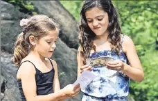  ??  ?? HIDE & $EEK: Piper and Tatum Sanders of Pittsburgh find some of the “Hidden Cash” in Central Park Saturday.