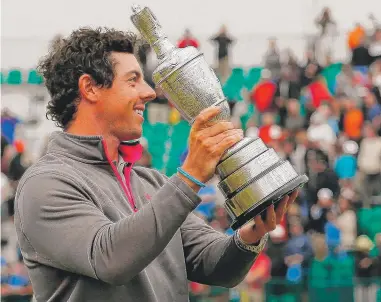  ?? | GETTY IMAGES ?? Rory McIlroy holds the claret jug aloft after his two-stroke victory Sunday in the British Open at Royal Liverpool.