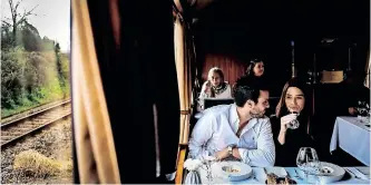  ?? | AFP ?? A COUPLE have a meal aboard the Presidenti­al Train during its trip to Douro, north of Portugal.