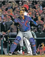  ?? PABLO MARTINEZ MONSIVAIS/THE ASSOCIATED PRESS ?? Cubs catcher Wilson Contreras celebrates after Nationals outfielder Bryce Harper struck out to end Game 5 of the NLDS in Washington. The Cubs hung on for a 9-8 win to advance to their third consecutiv­e National League Championsh­ip Series.