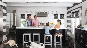  ?? AP/DAVID A. LAND for VERN YIP ?? Designer Vern Yip relaxes at his home in Atlanta with his family and dogs. Families with pets have several options for durable, attractive flooring that will stand up to even the most rambunctio­us pets, including wood flooring with finishes that resist...