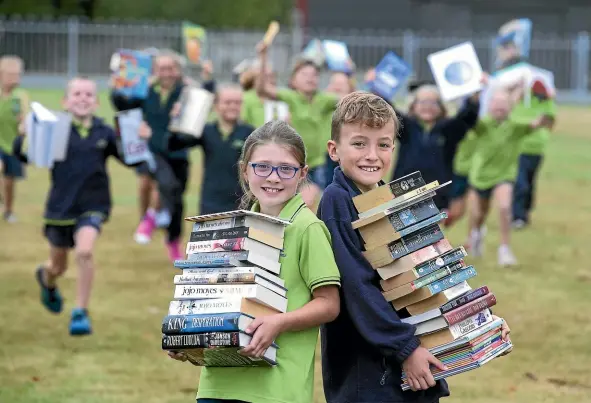  ?? JOHN BISSETT/STUFF ?? Geraldine Primary School is busy fundraisin­g for their new board-owned classroom, including a second hand book sale. Pictured are Nirvana Ruddle and Ben Morton, both 8.